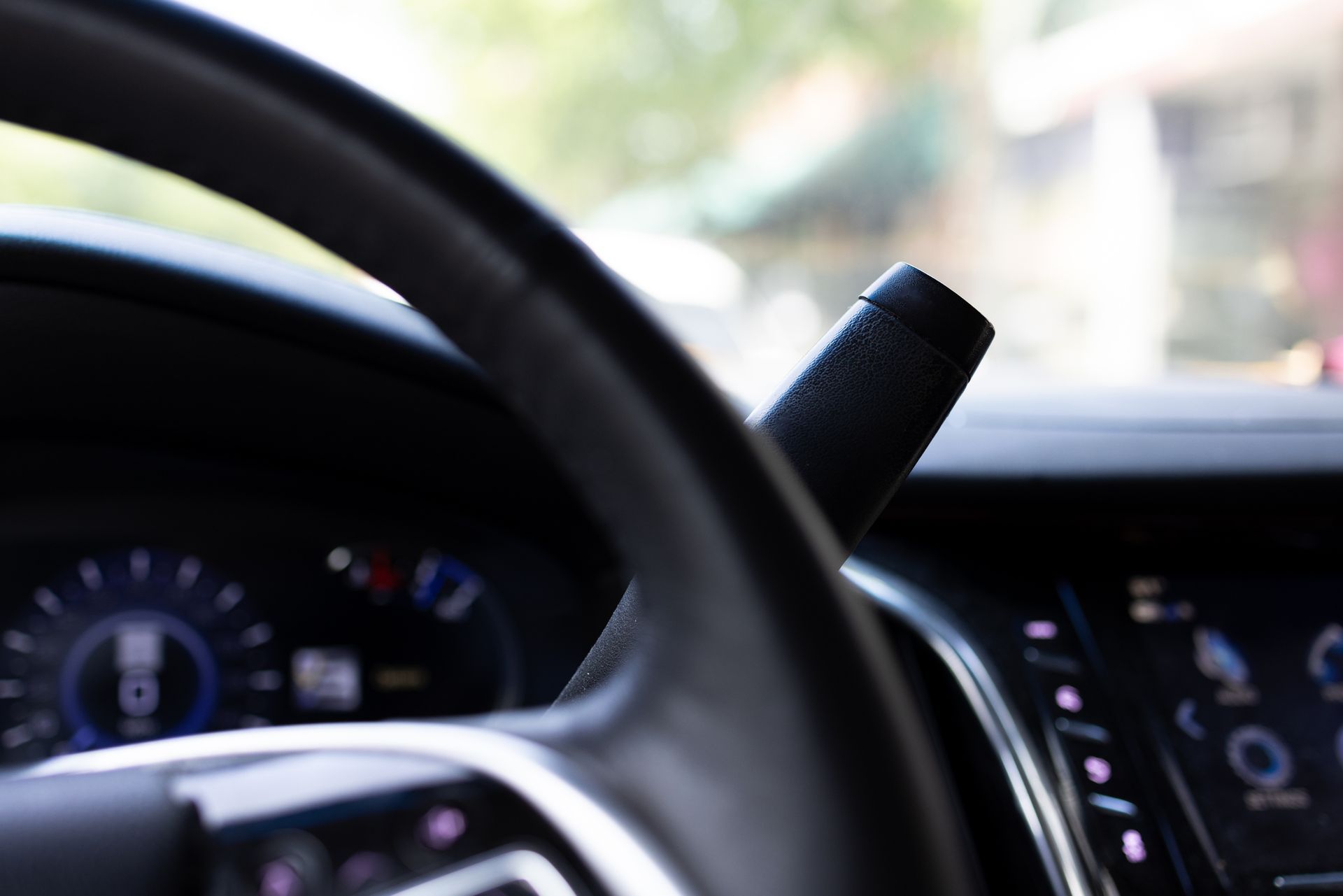 A close up of a car steering wheel and dashboard
