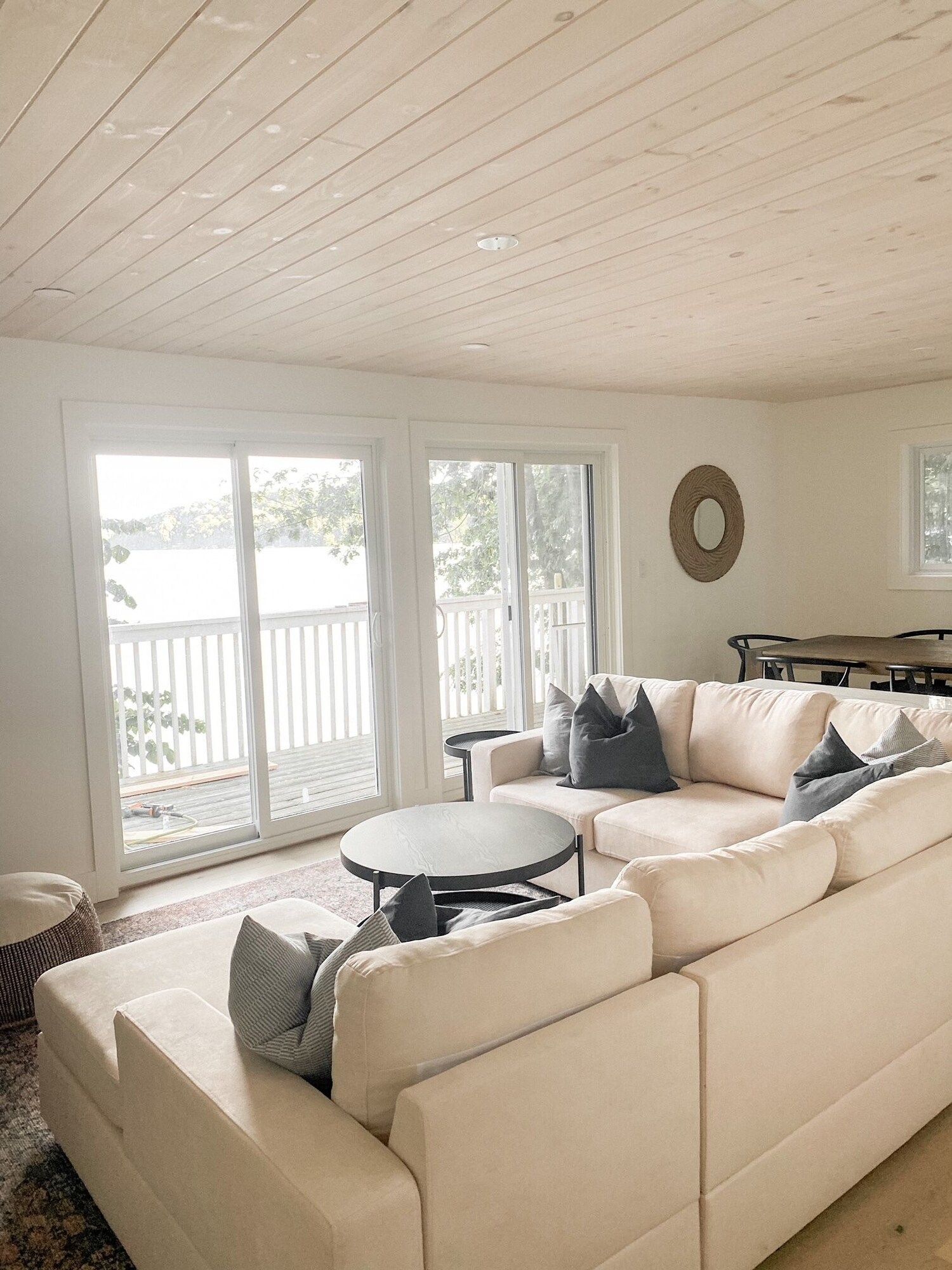 A living room with a couch , table , and sliding glass doors.