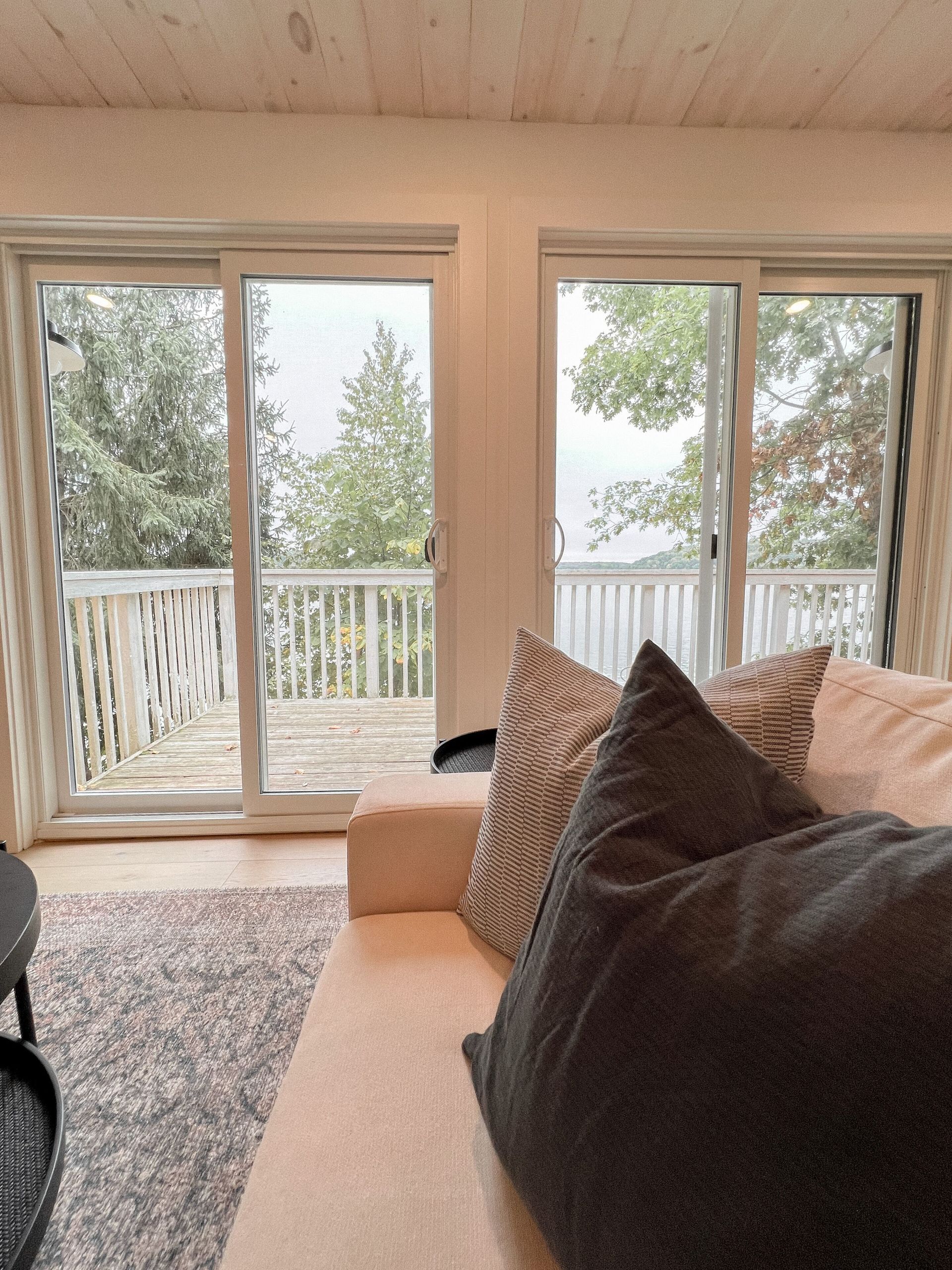 A living room with a couch and sliding glass doors leading to a deck.