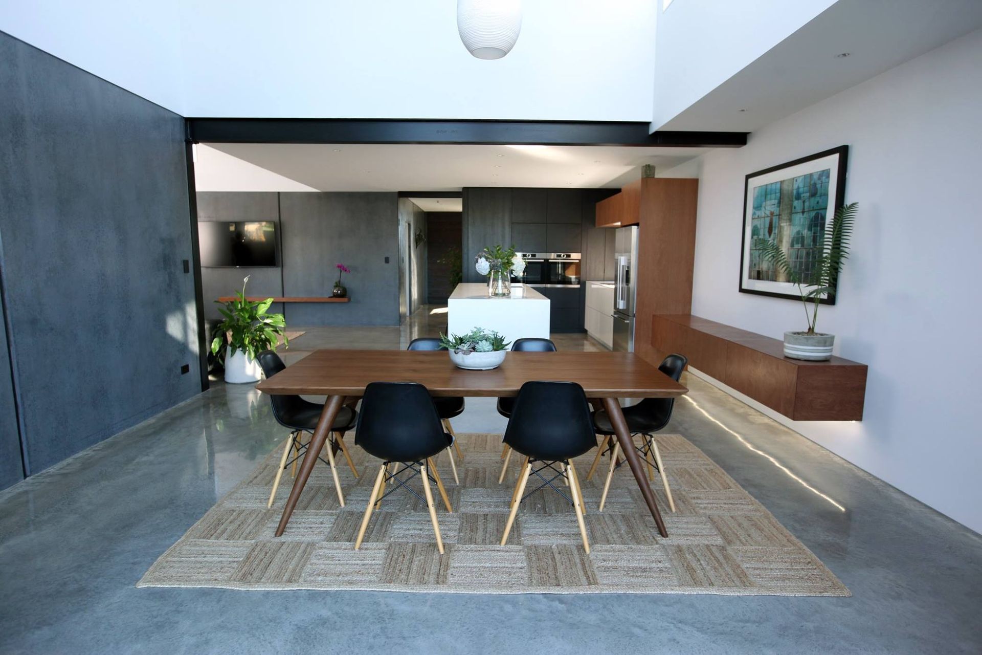 Dining room with kitchen and living area in the background