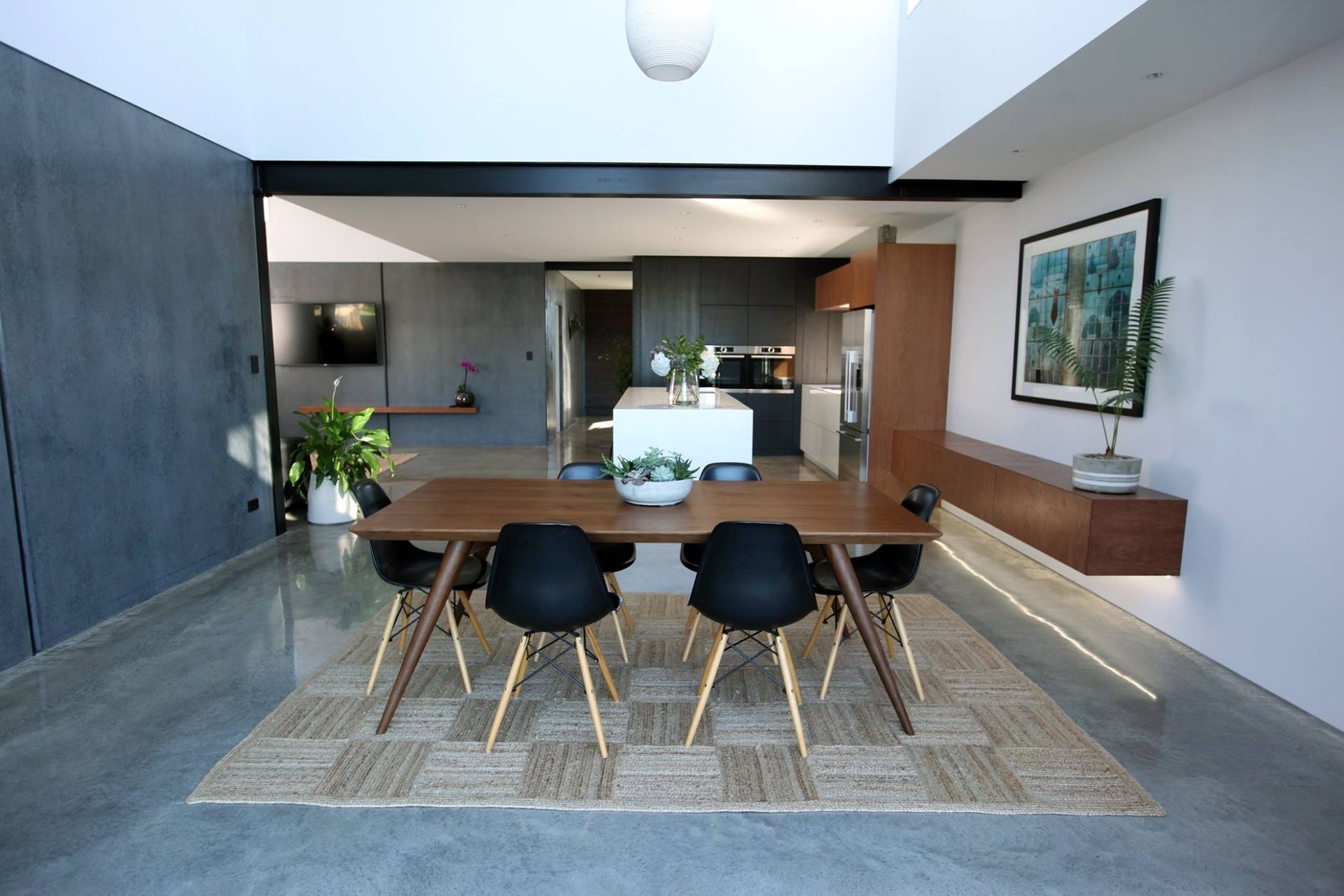 A dining room with a table and chairs and a rug