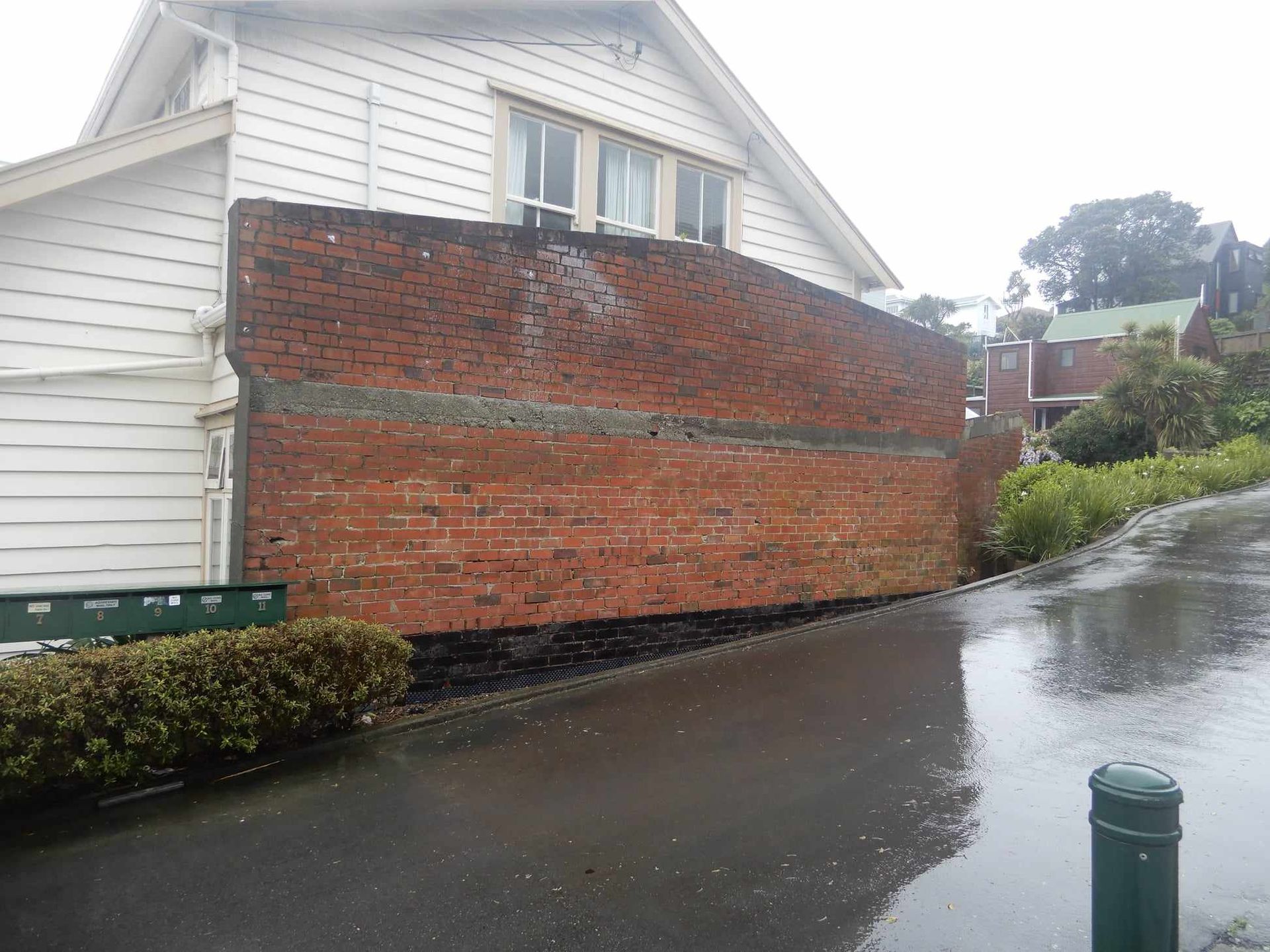 earthquake damaged wall gets reinforced and reclad