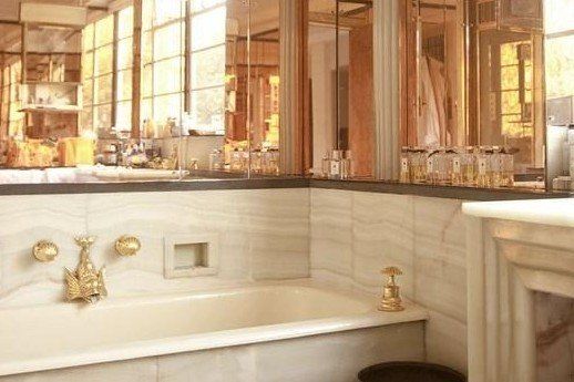 A bathroom with a bathtub , sink and mirrors