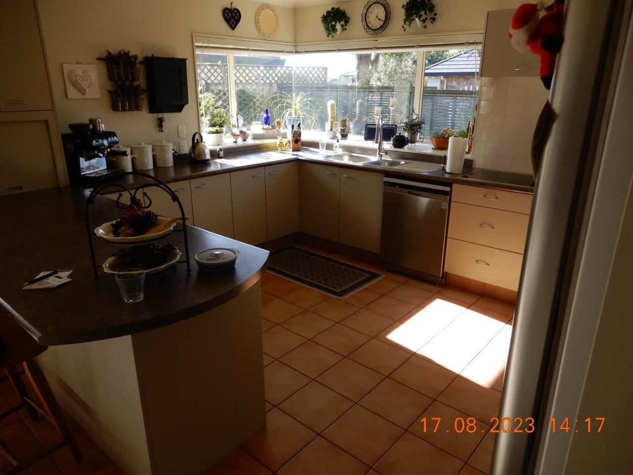 A kitchen with white cabinets and a stainless steel dishwasher