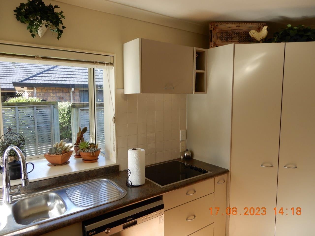 A kitchen with a sink a stove and a window