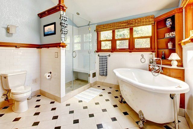 A bathroom with a bathtub , toilet , and shower.