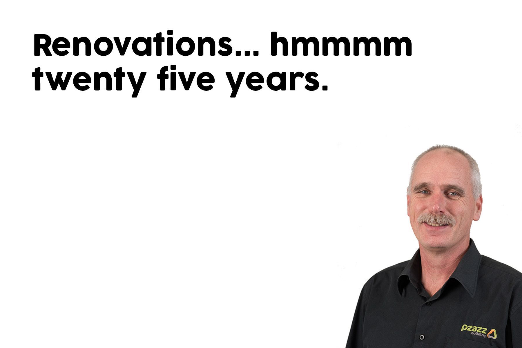 A man in a black shirt is standing in front of a white background.