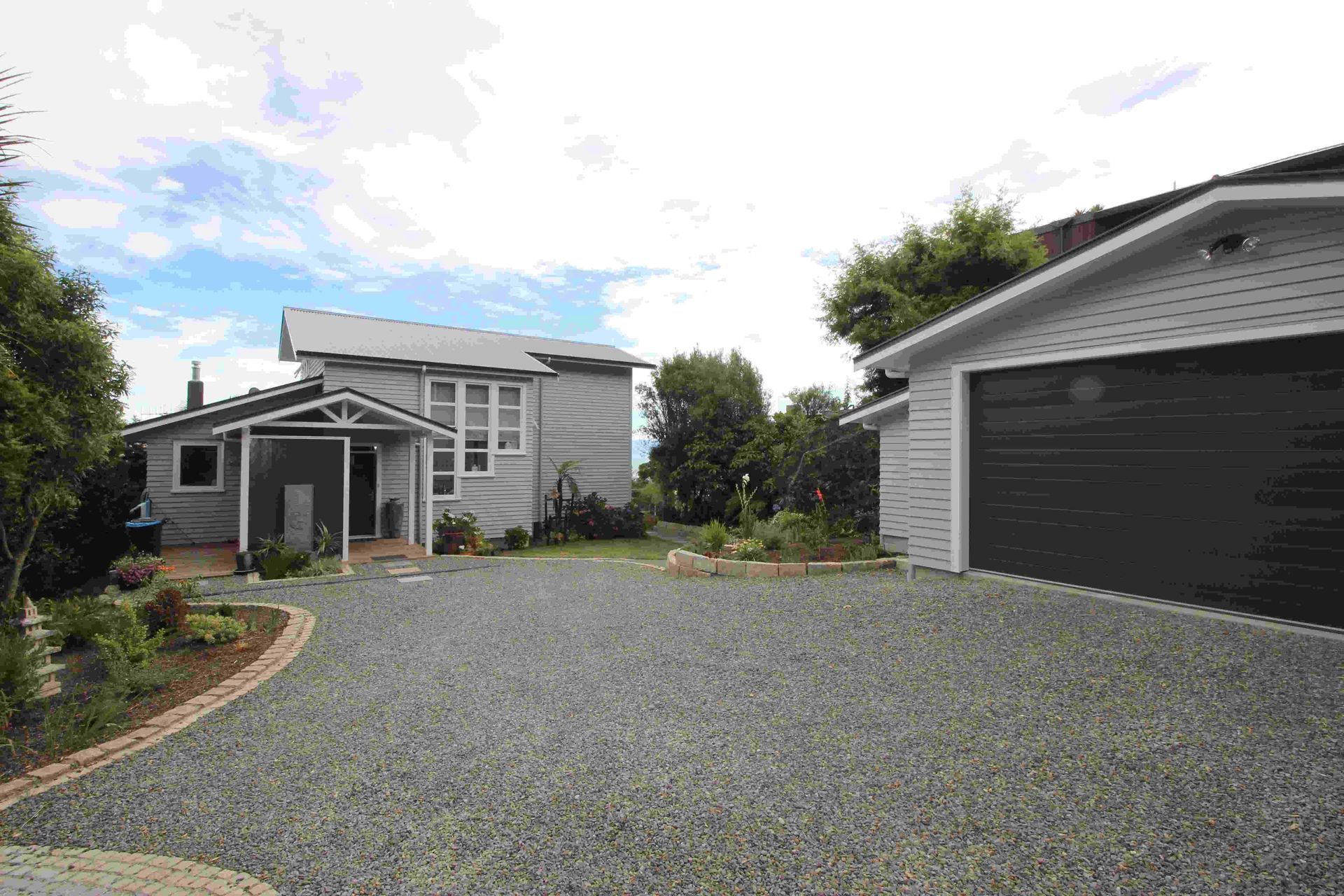 A house with a driveway leading to it and a garage.
