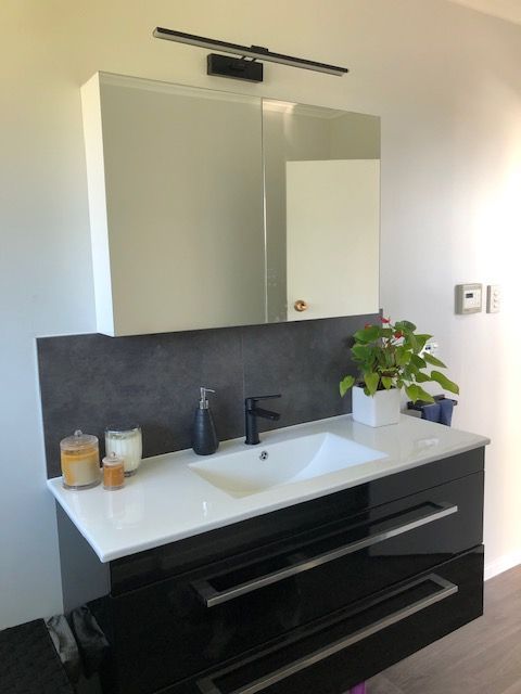striking black bathroom vanity with large mirror