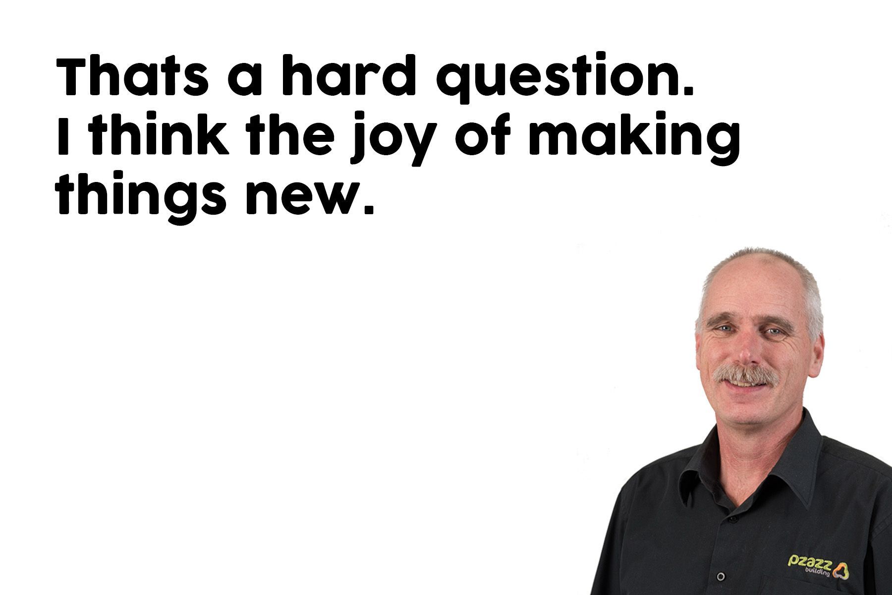 A man in a black shirt is standing in front of a white background.