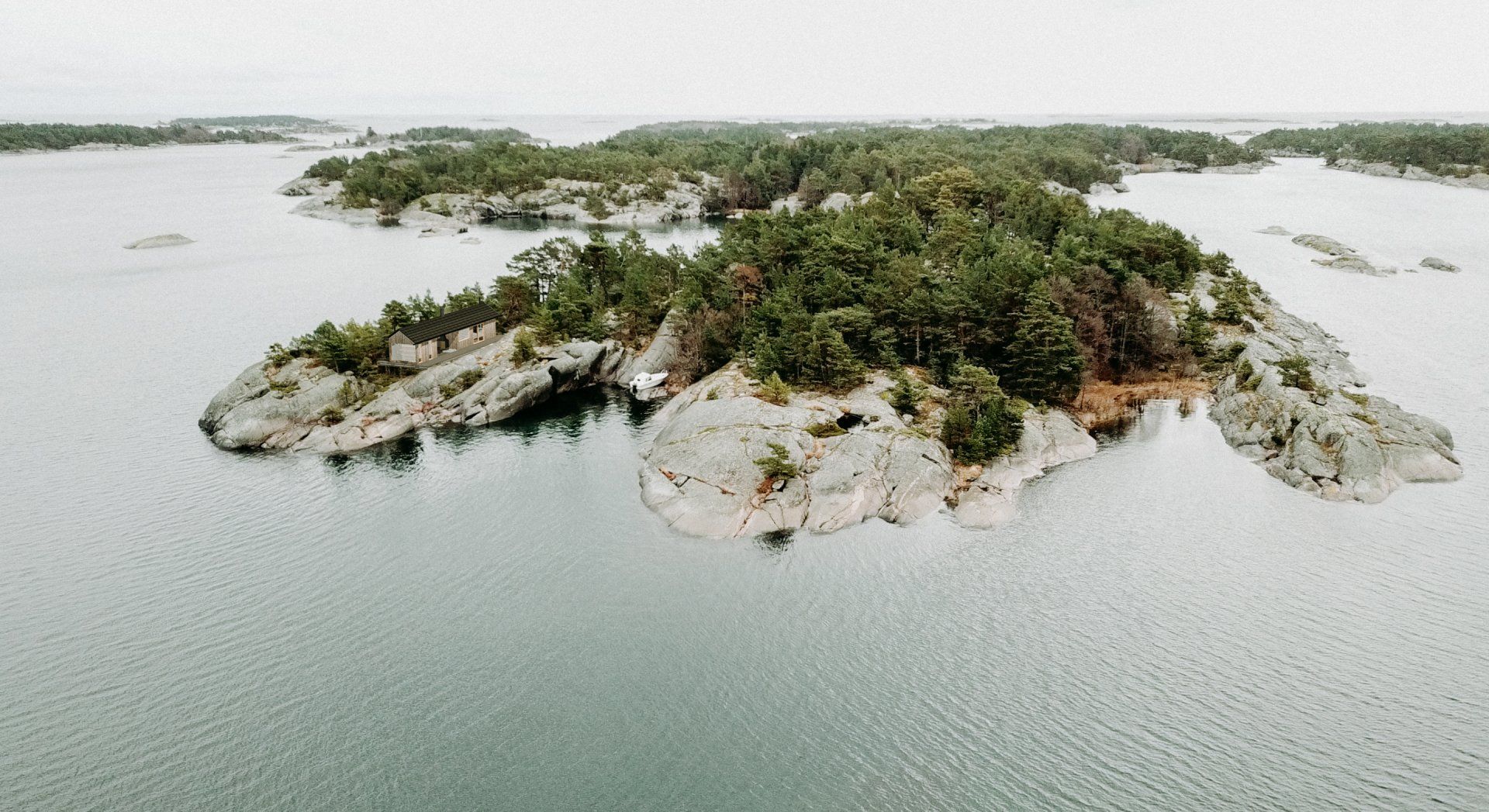 An aerial view of a small island in the middle of a large body of water.