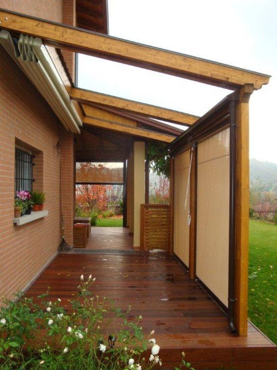 A house with a wooden deck and a clear roof