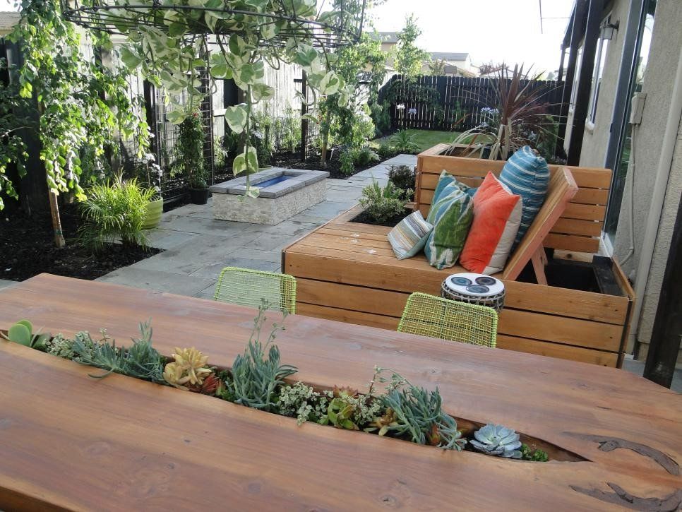 A wooden table with plants growing out of it