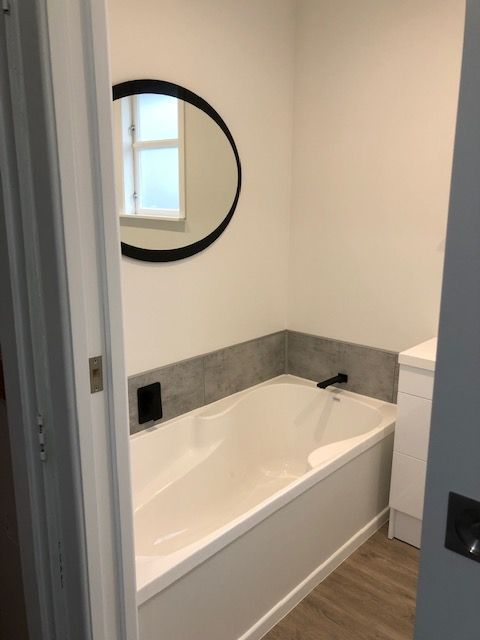 bathroom with tub and vanity after renovation