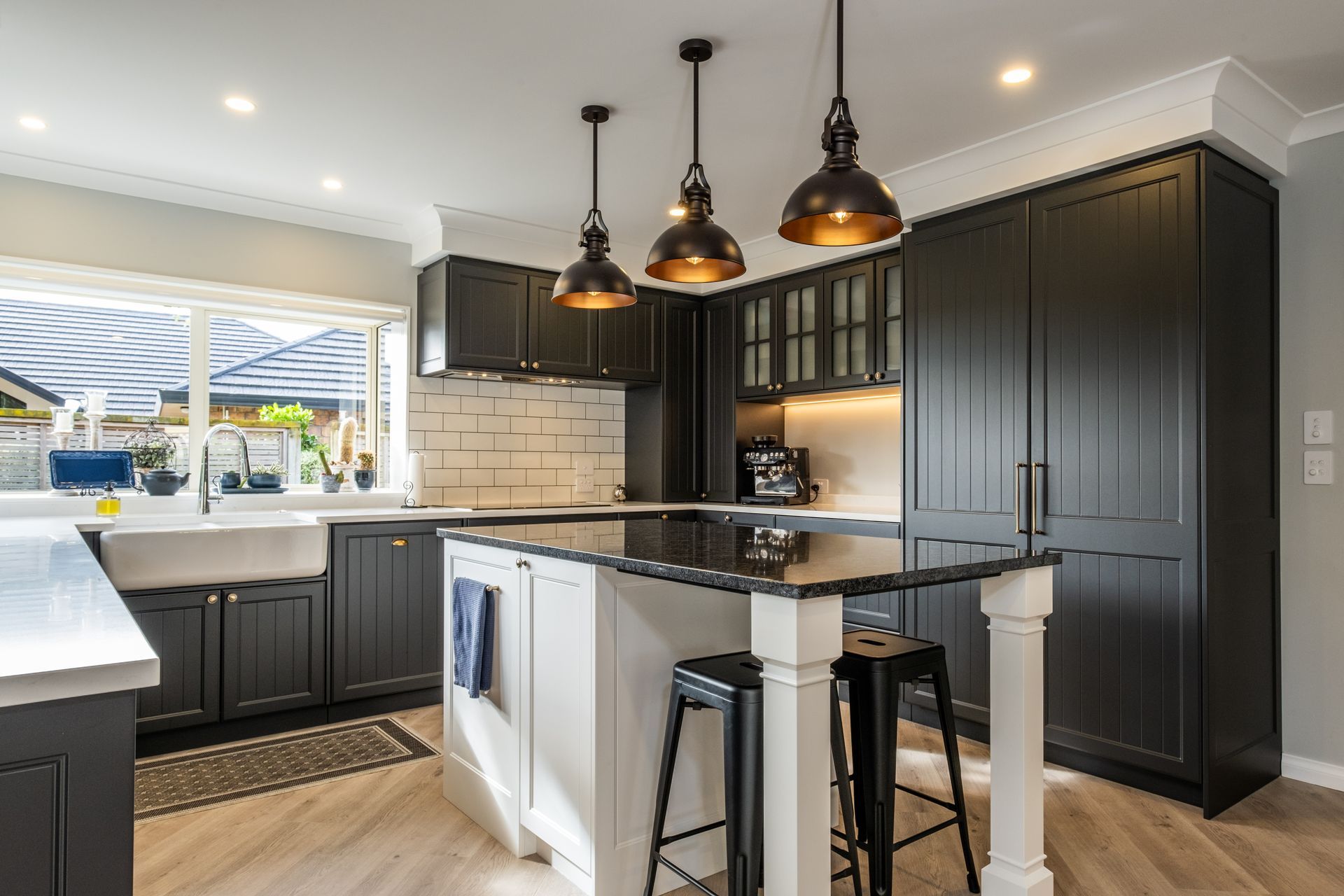 A kitchen with black cabinets and a black counter top.