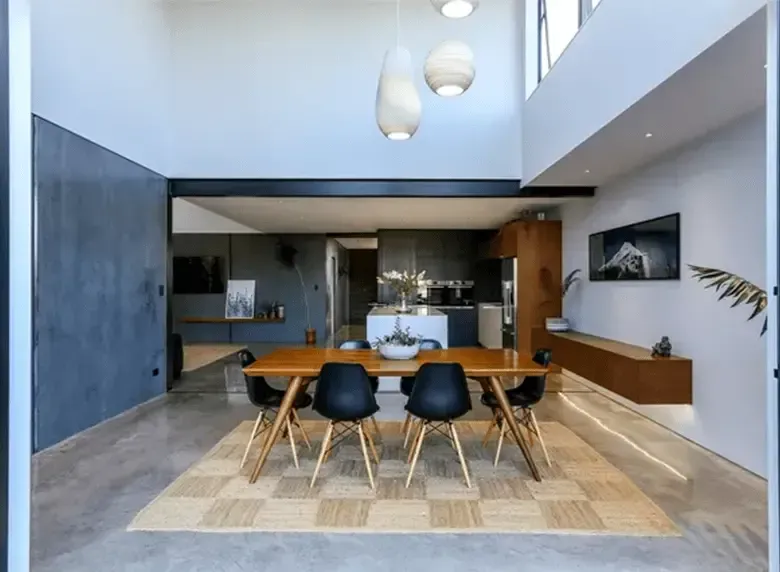 A dining room with a table and chairs in it