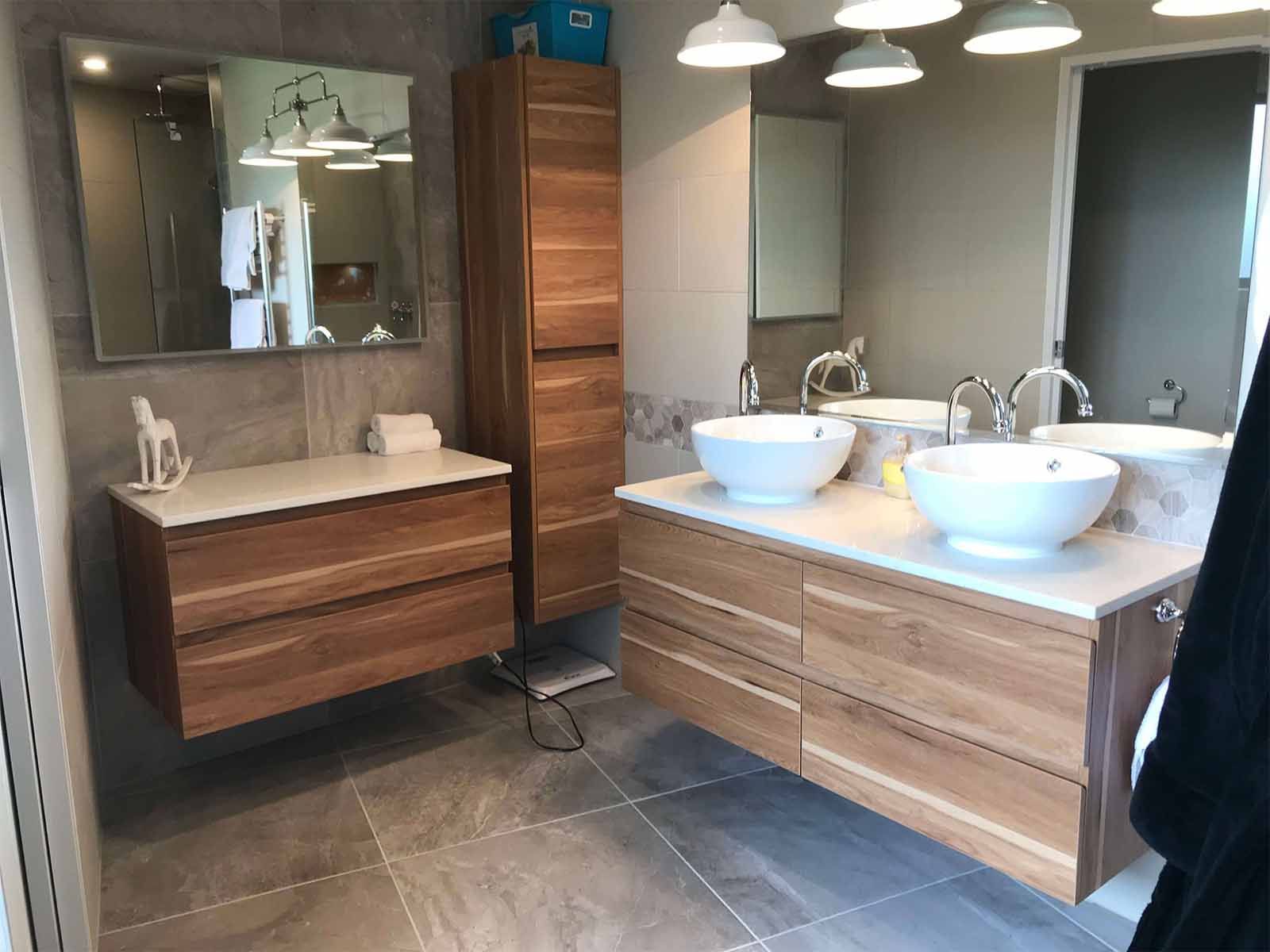 ensuite featuring timber vanity and storage