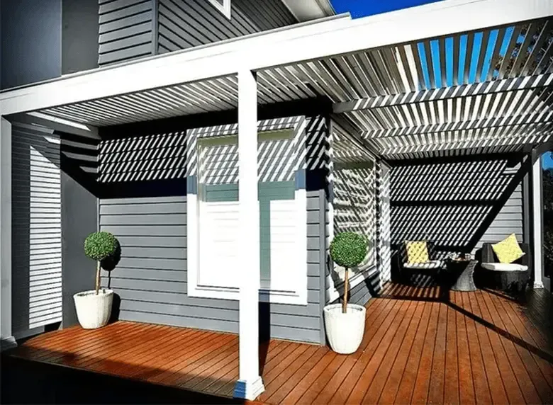 A house with a pergola and a wooden deck