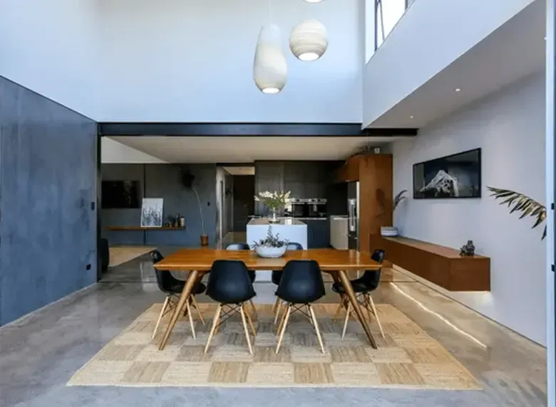 A dining room with a table and chairs in it