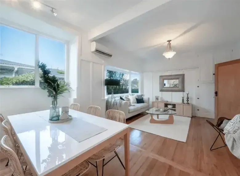 A living room with a table and chairs and a couch