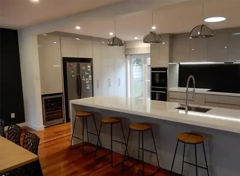 A kitchen with a large island and stools