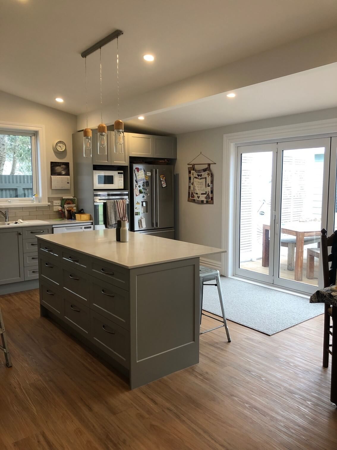 3D design render of a modern renovated bathroom. Wood panel wall and a timber vanity. By Pzazz Building.