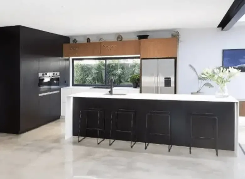 A kitchen with a large island and stools