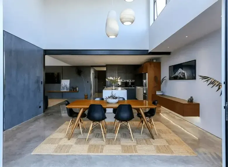 A dining room with a table and chairs in it