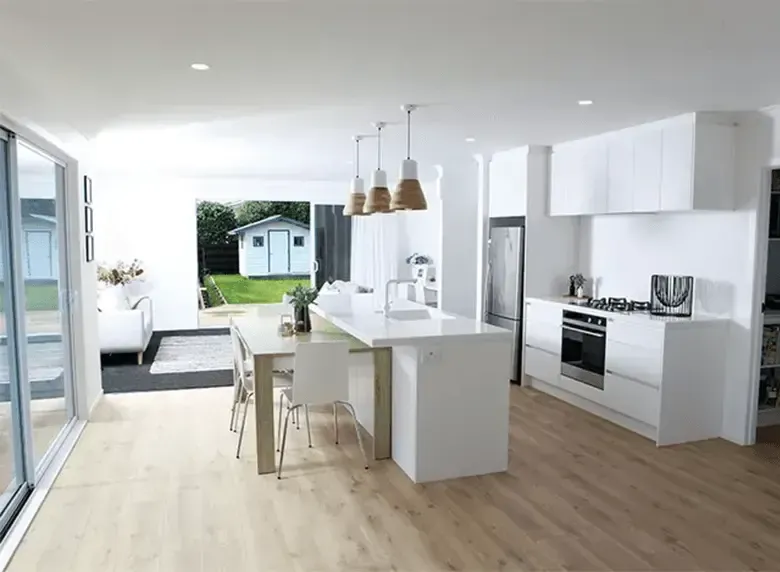 An artist 's impression of a kitchen with white cabinets and wooden floors.