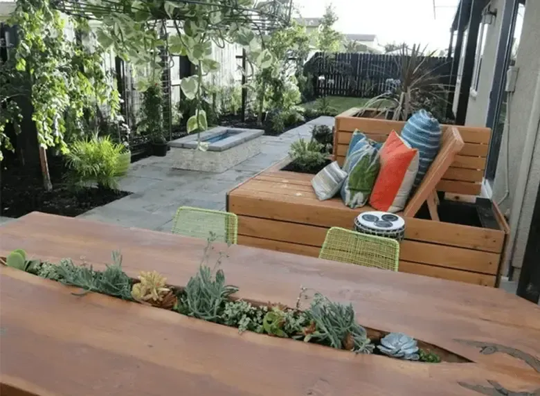 A wooden table with plants growing out of it