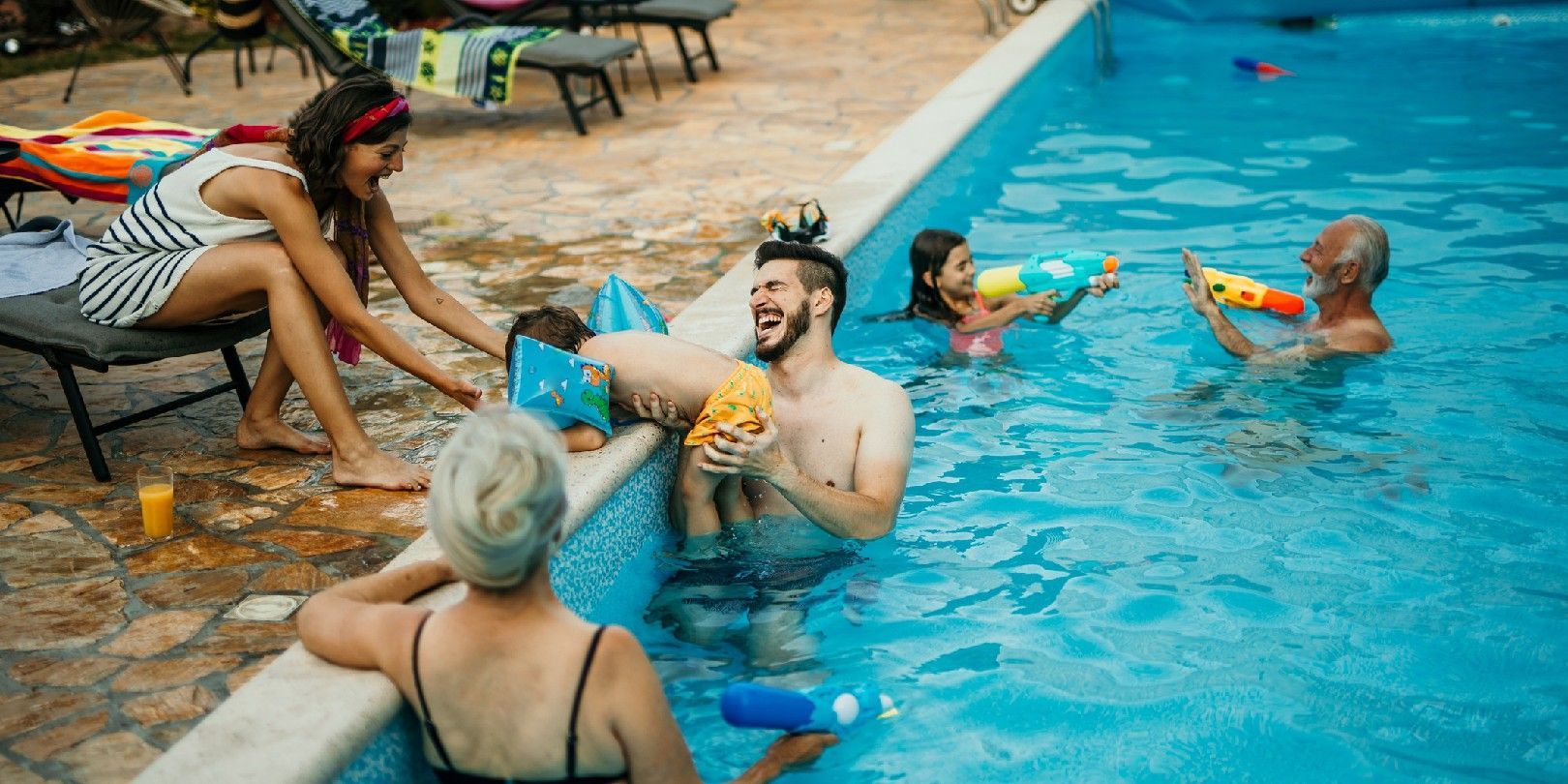 A group of people are playing in a swimming pool.