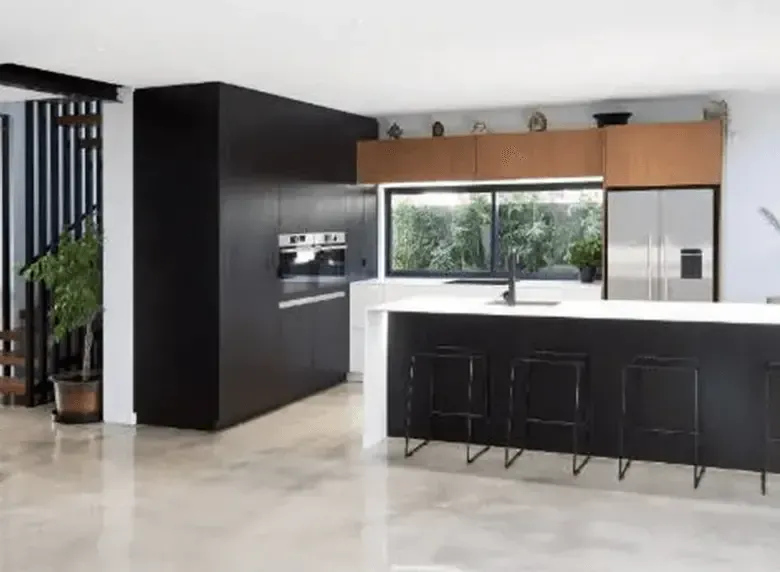 A kitchen with black cabinets and white counter tops