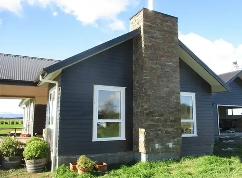 A house with a chimney on the side of it