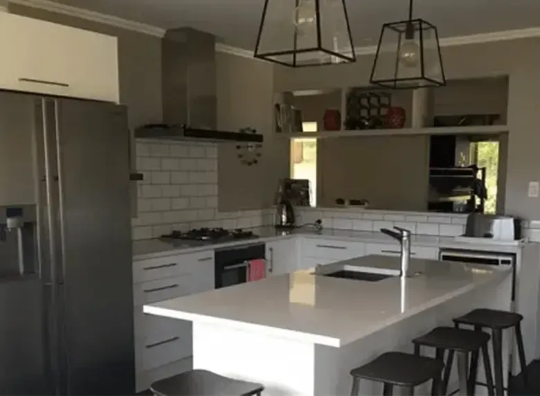 A kitchen with a large island and stools