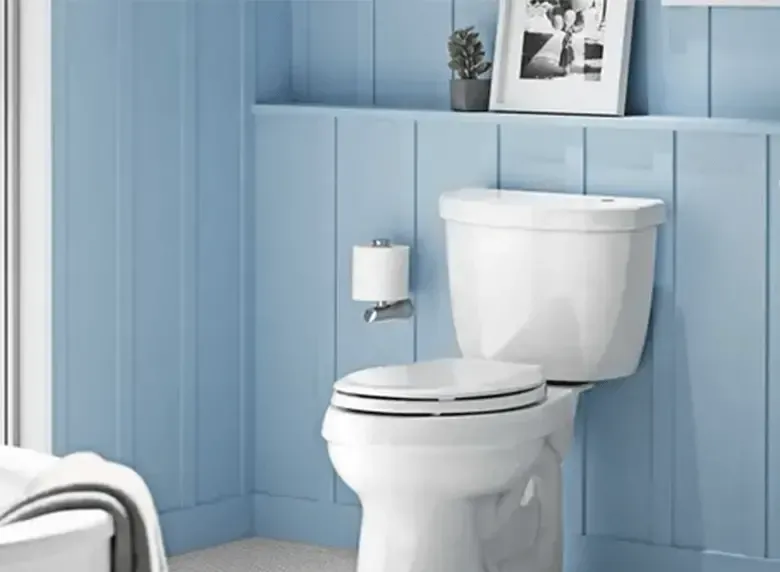 A bathroom with blue walls and a white toilet