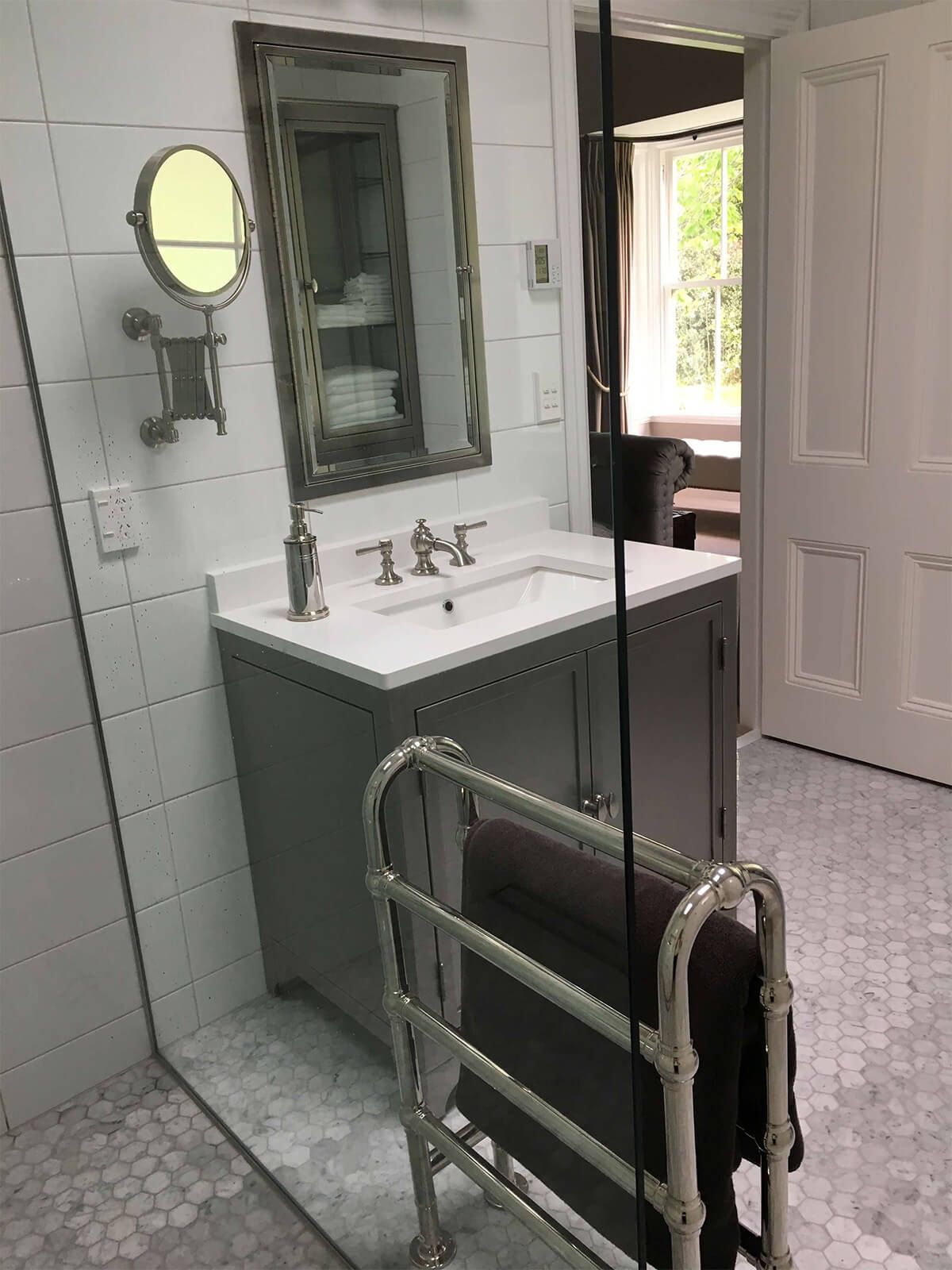 stylish towel rail with hex floor tiles