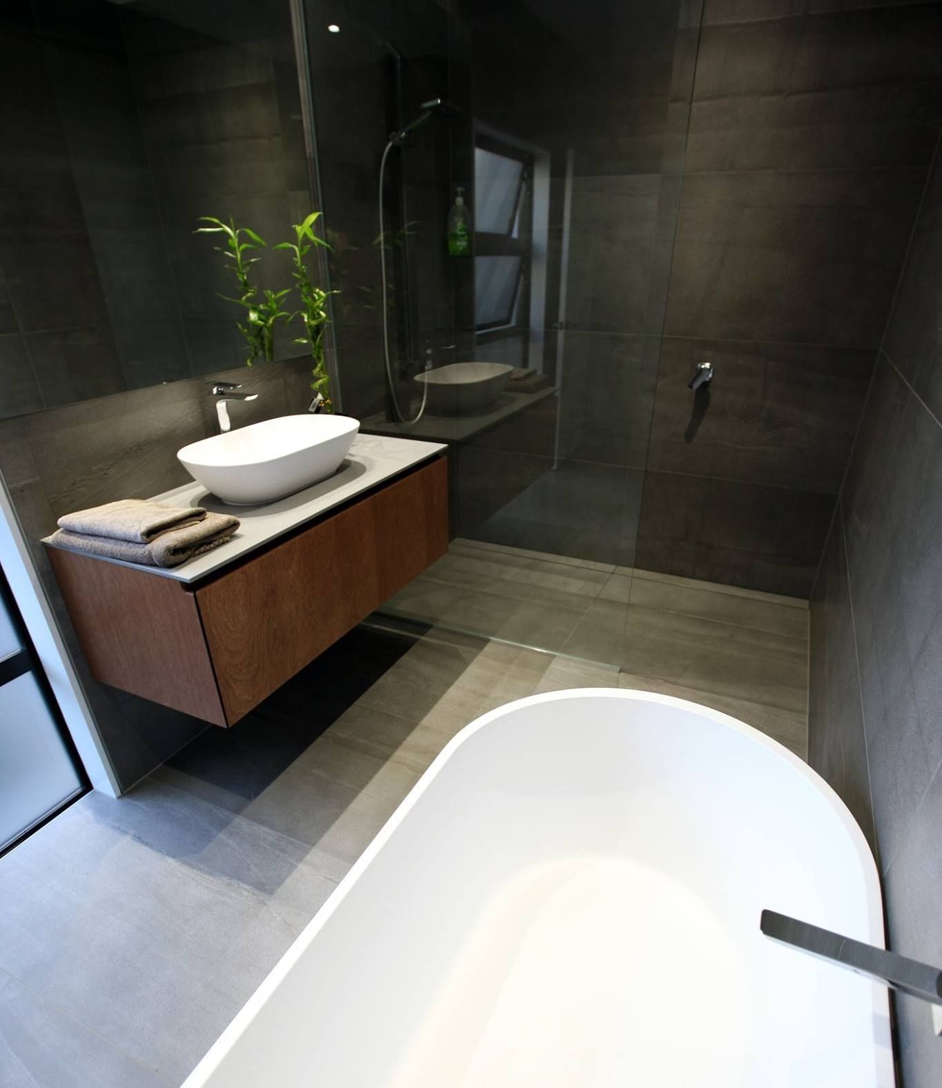 A bathroom with a bathtub , sink and shower