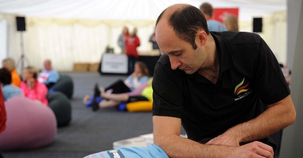 Richard massaging runners after event, Coventry.