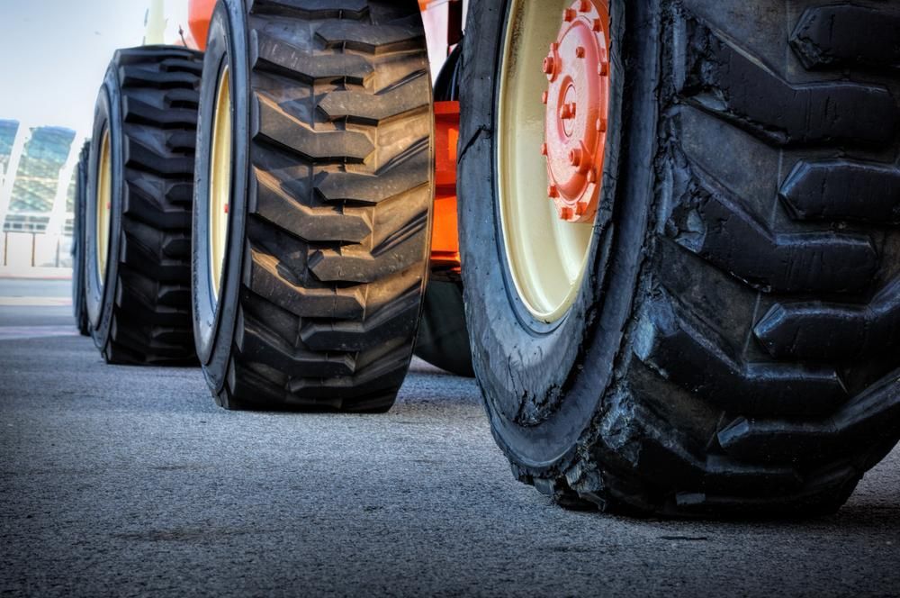 A Close Up of a Row of Tractor Tires on a Road — Wheel Alignment Centre In Braitling, NT