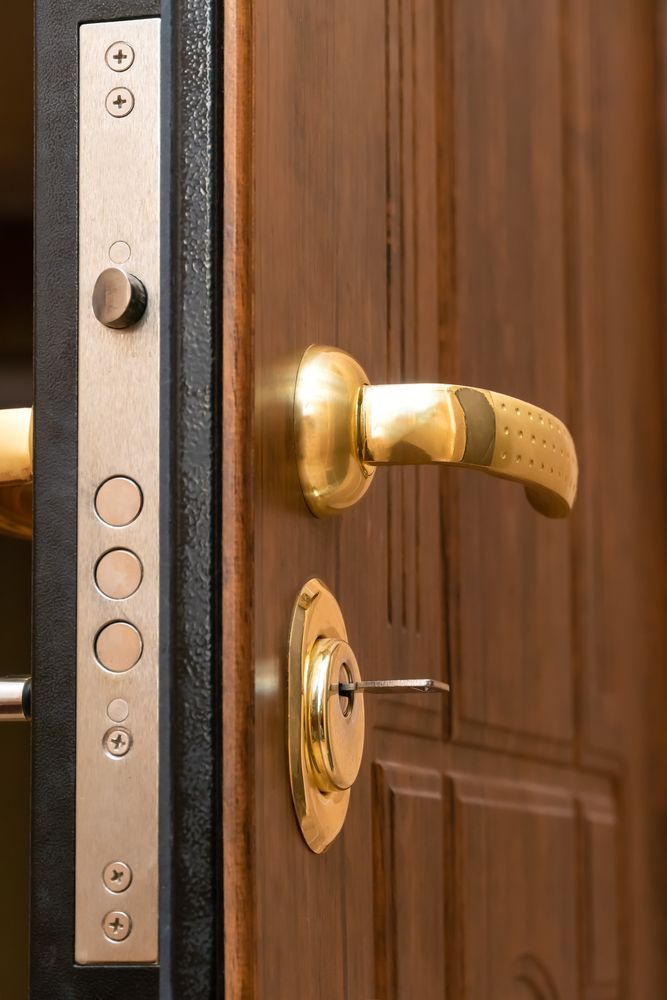Gold Handle And Lock Key Of Wooden Door — New Lock & Safe Services in Camperdown, VIC