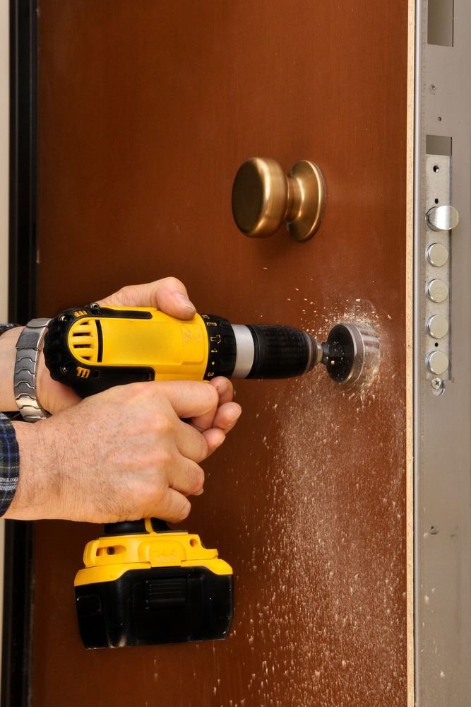 Someone Fixing The Door Lock — New Lock & Safe Services in Port Campbell, VIC