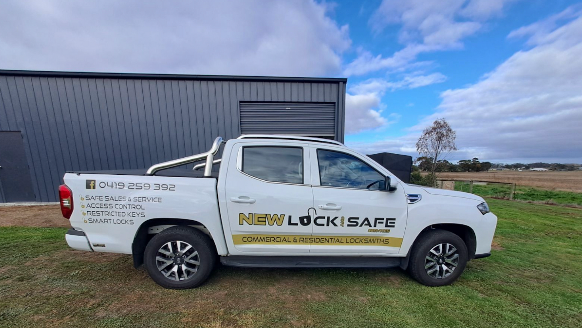 Newlock & Safe Work Ute Parked on Grass — New Lock & Safe Services in Terang, VIC