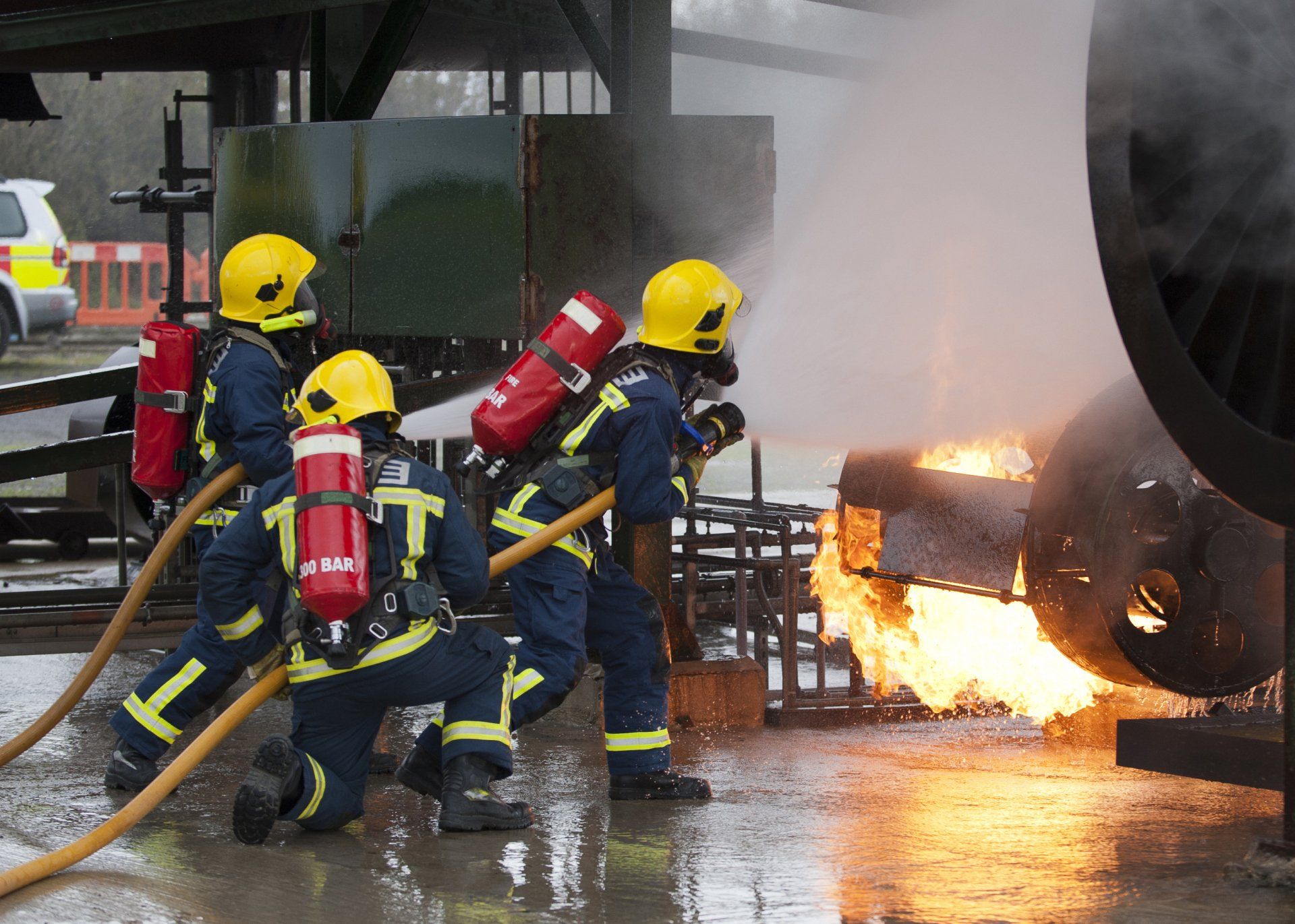 A group of firefighters are spraying water on a fire