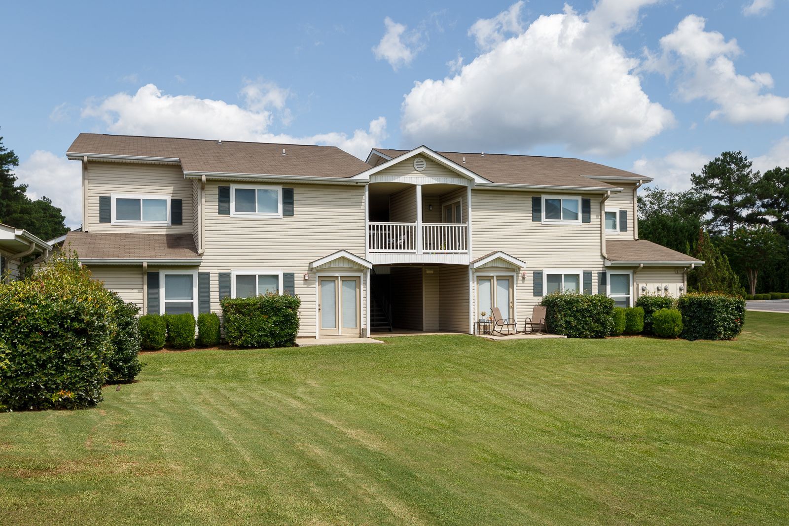 A large house with a lush green lawn in front of it