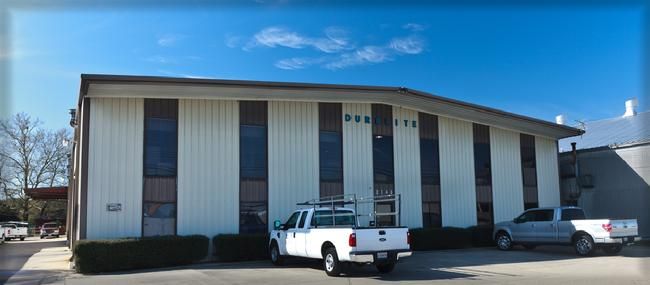A white building with tall windows and the word