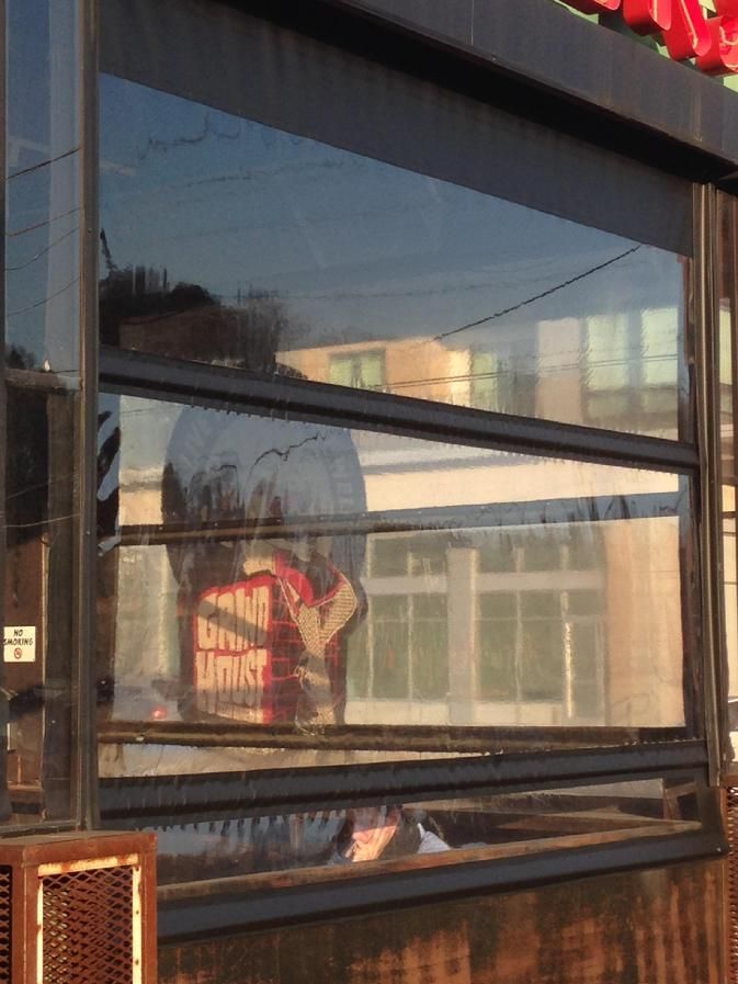 a reflection of a building in a window with the word limit on it