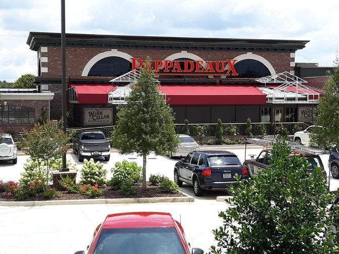 a red car is parked in front of a restaurant called pappaderick