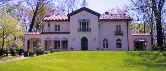 A large house with a lush green lawn in front of it