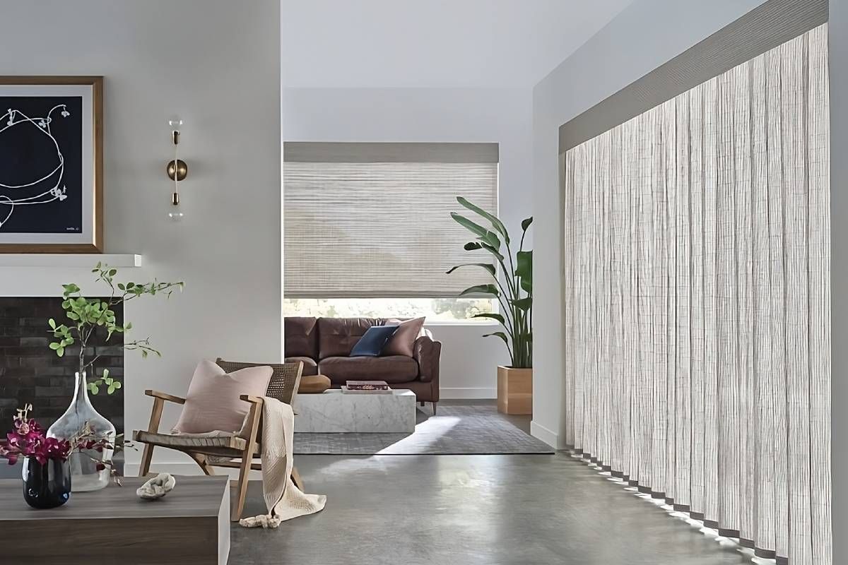 Neutral woven wood shades on large windows in a stylish and chic living room