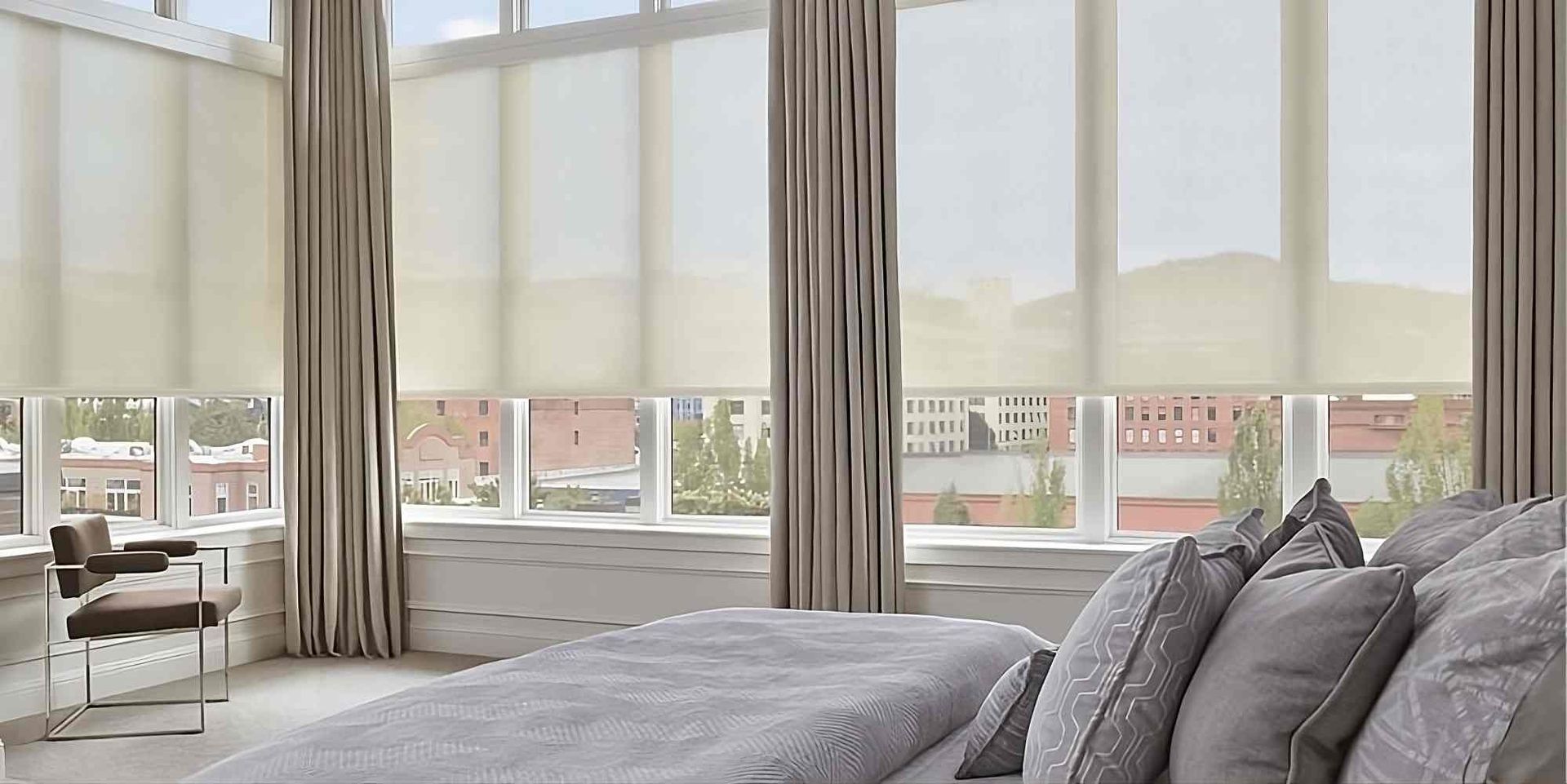 Functional and customizable Hunter Douglas Designer Solar Shades on large windows in a stylish bedroom at The Blind Guy Lewiston near Clarkston & Pullman, WA